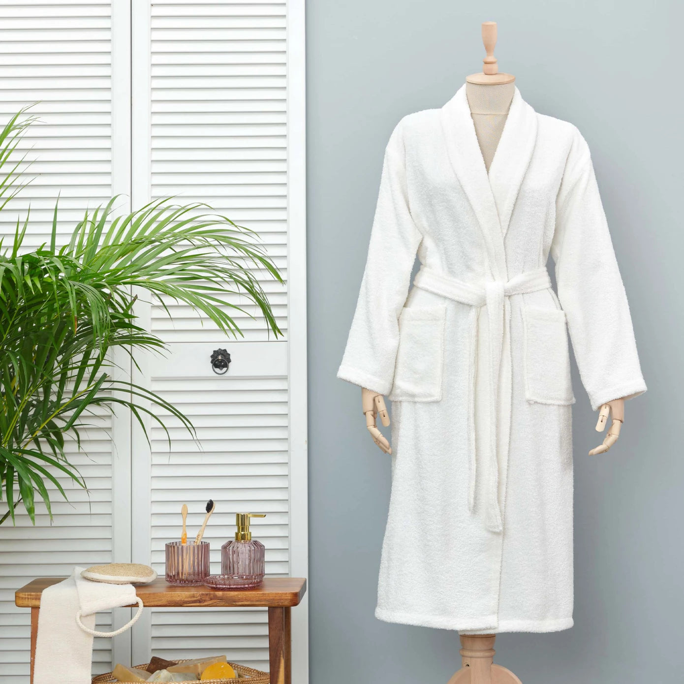 White bathrobe made from 100% cotton, providing a soft and comfortable experience.