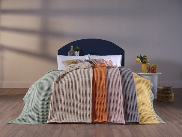 Cream-colored queen size blanket, providing warmth and comfort.